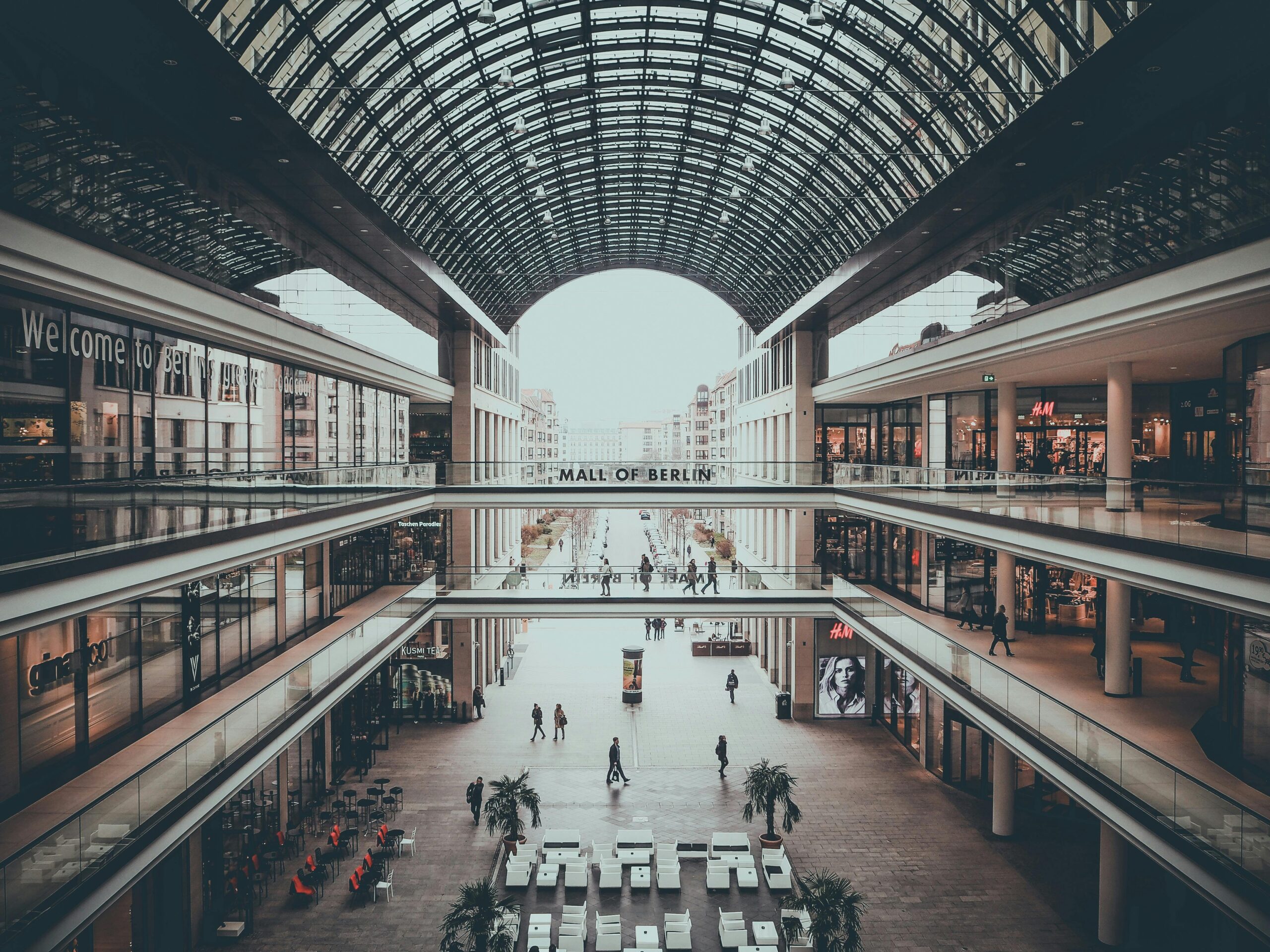 Explore the sleek and multi-level design of Mall of Berlin, showcasing modern architecture and shoppers.