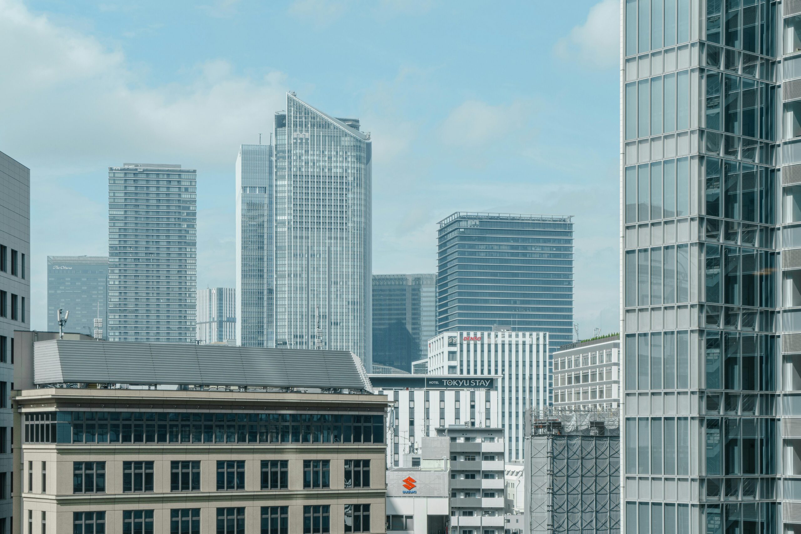 Cityscape featuring glass skyscrapers under a clear blue sky, ideal for urban themes.